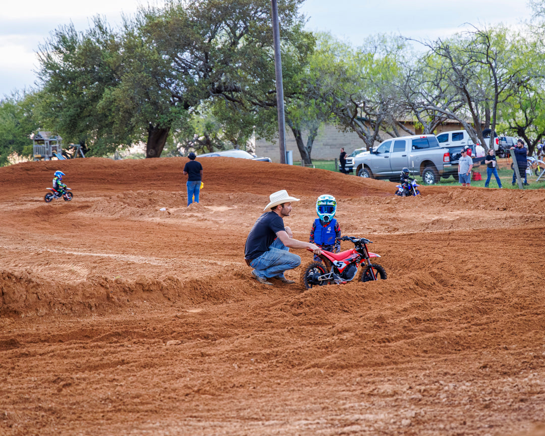 FATHER INSTRUCTS SON HOW TO RIDE A DIRT BIKE