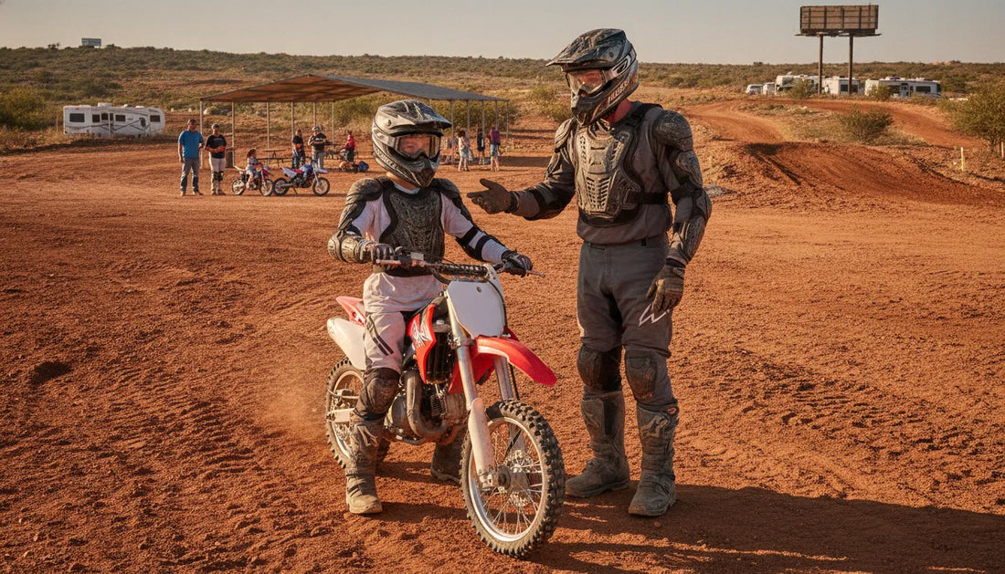 Instructor guiding a first-time dirt bike rider at an outdoor motocross facility