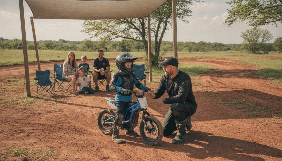 Child learning to ride a small dirt bike with a coach at a motocross birthday party